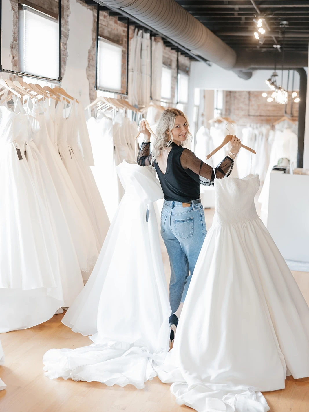 Bridal stylist with wedding gowns